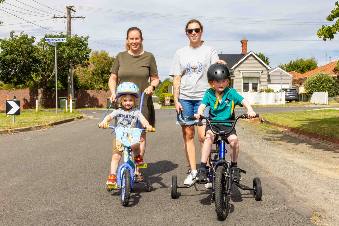 Louise and Georgia pushing Ethan and his brother on bikes