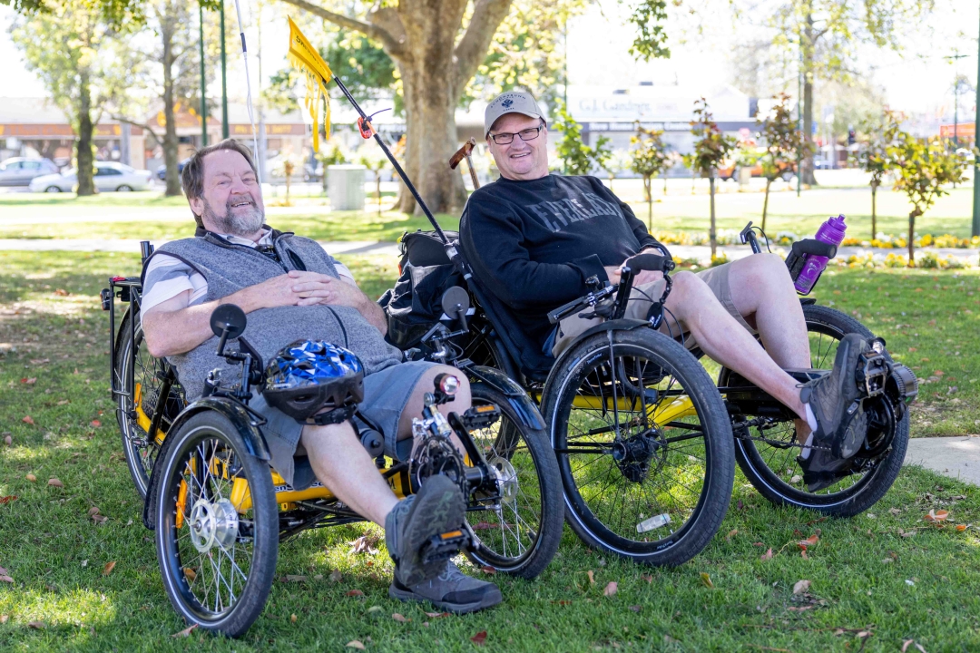 Michael and his support worker Kevin on recumbent bikes